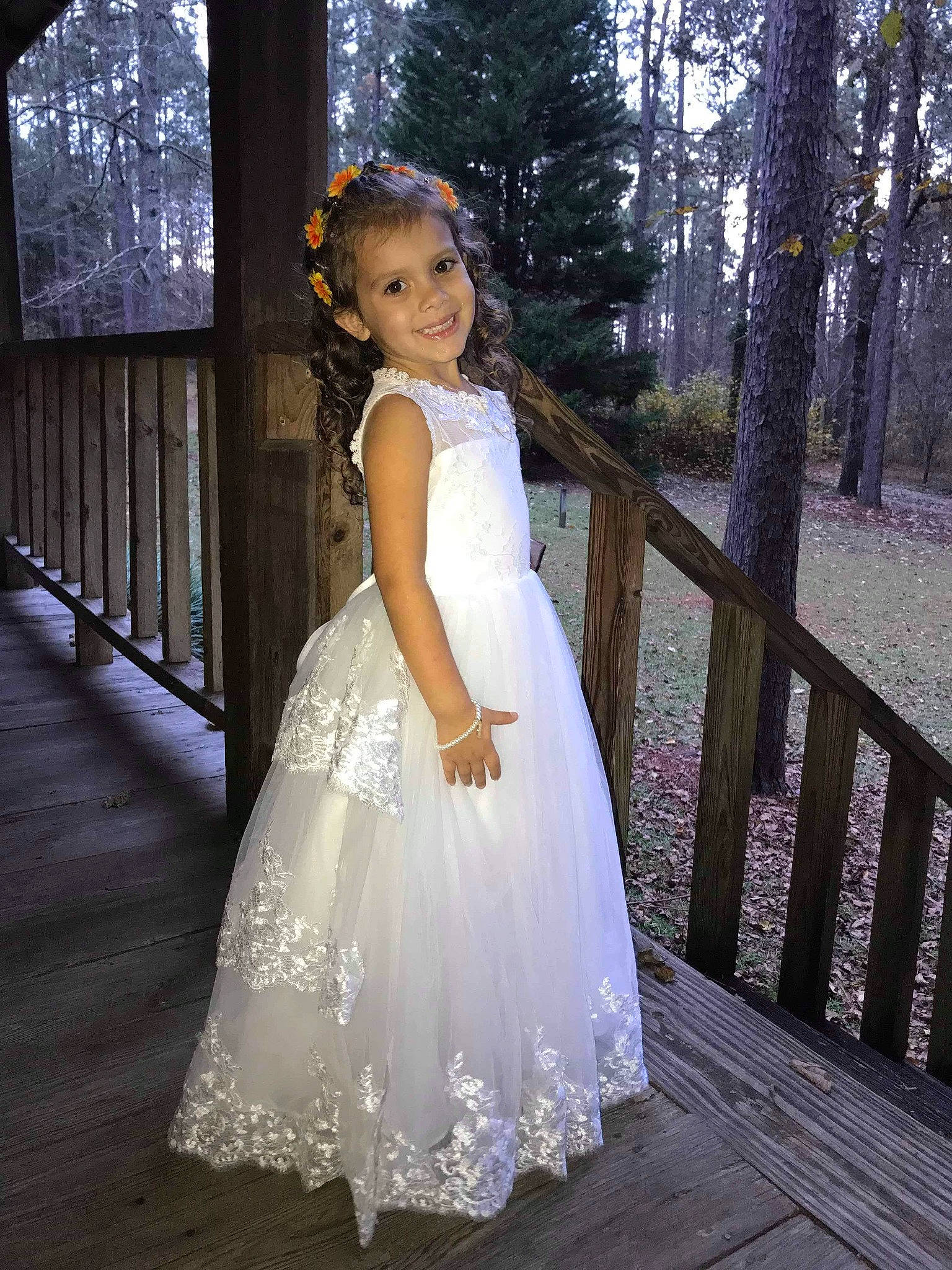 Jennica is registered to the contest to win money with this photo: bridal_accessory, bridal_clothing, bridal_party_dress, dress, flash_photography, formal_wear, gown, happy, headpiece, human_body, joy, one_piece_garment, people_in_nature, person, shoulder, smile, toddler, tree, waist, wedding_ceremony_supply