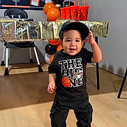 Luisniel joined the competition — help win amazing prizes! background, balloons, basketball_theme, black_clothing, boy, cap, celebration, child, cups, decorations, floor, happy, indoor, party, smiling, sneakers, sportswear, standing, table, toddler