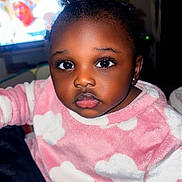 Amynatha participe au concours pour gagner de l'argent avec cette photo : child, toddler, baby, onesie, pajamas, pink_clothing, cloud_pattern, face, eyes, big_eyes, eyelashes, hair, earring, portrait, indoor, television, background, blanket, candid, soft_fabric