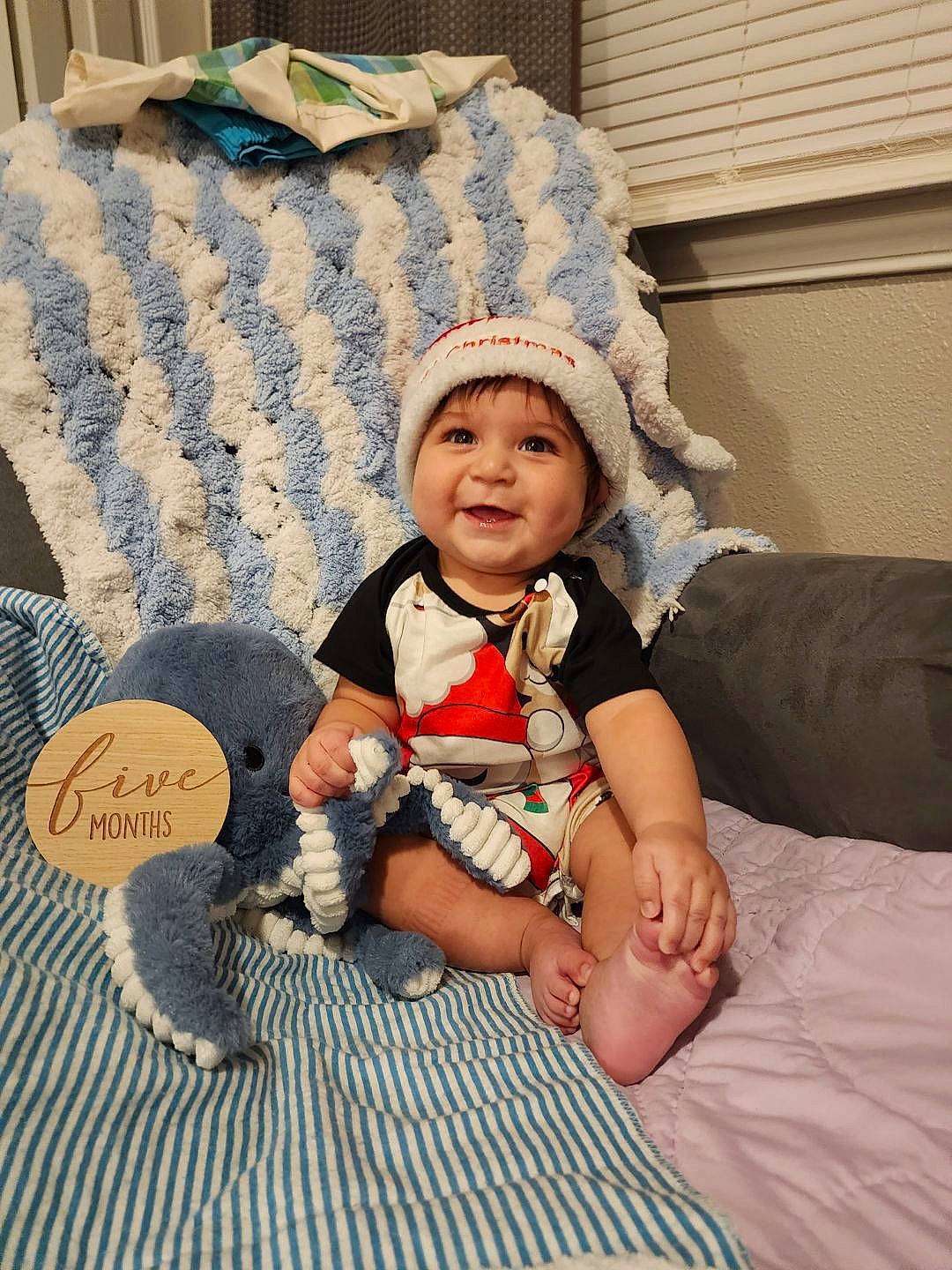 Alanzo joined the competition — help win amazing prizes! baby, baby_toddler_clothing, cap, child, comfort, costume_hat, couch, fashion_accessory, flooring, happy, headgear, headwear, joy, linens, pattern, person, room, sitting, sock, sun_hat