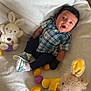 Kyrie is registered to the contest to win money with this photo: baby, bed, bedroom, blanket, clothing, couch, cushion, face, furniture, head, homedecor, hosiery, indoors, person, photography, plush, portrait, room, sock, toy