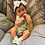 baby, infant, child, cute, sitting, couch, headband, bow, socks, clothing, wooden_sign, three_months, fingers, portrait, indoor, soft_lighting, happy, smiling, curious, comfortable