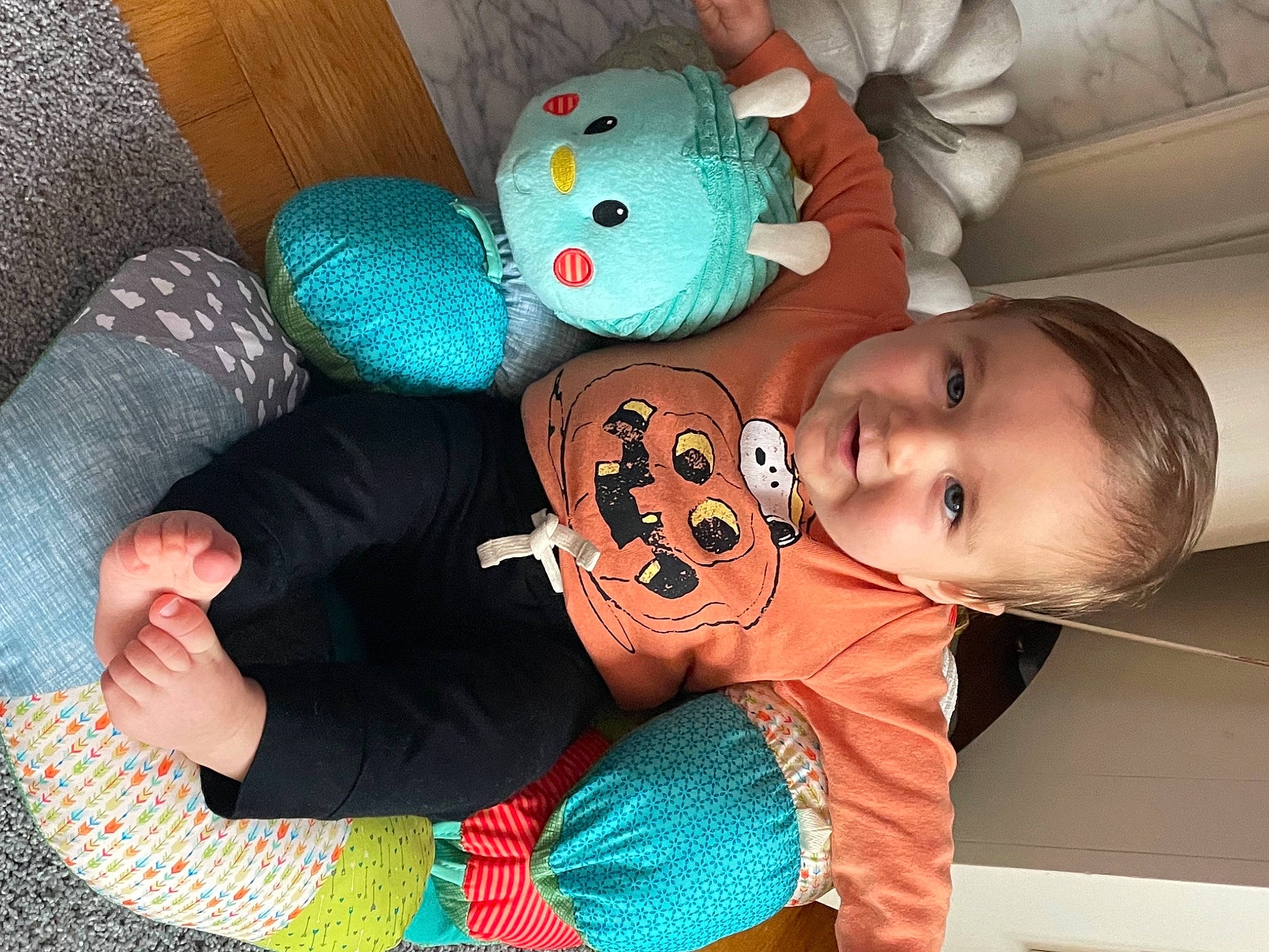 Joey is registered to the contest to win money with this photo: baby, baby_products, baby_toddler_clothing, cheek, child, comfort, finger, fun, green, head, headgear, leg, mouth, nose, organ, person, skin, smile, stuffed_toy, textile