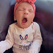 Elliana joined the competition — help win amazing prizes! baby, infant, yawning, headband, bow, pink, onesie, bunny, sitting, couch, leather, sock, sleepy, cute, child, portrait, indoors, soft_light, apparel, newborn