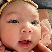Isabella joined the competition — help win amazing prizes! baby, close_up, face, headband, bow, skin, eyes, mouth, hand, infant, cute, adorable, person, child, expression, soft_lighting, pink_clothing, newborn, portrait, human