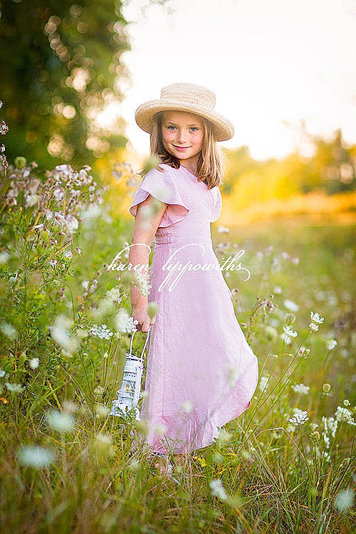 Harper is registered to the contest to win money with this photo: day_dress, dress, flash_photography, flower, gown, grass, grassland, happy, hat, headwear, joy, long_hair, meadow, natural_landscape, people_in_nature, person, petal, plant, sky, smile