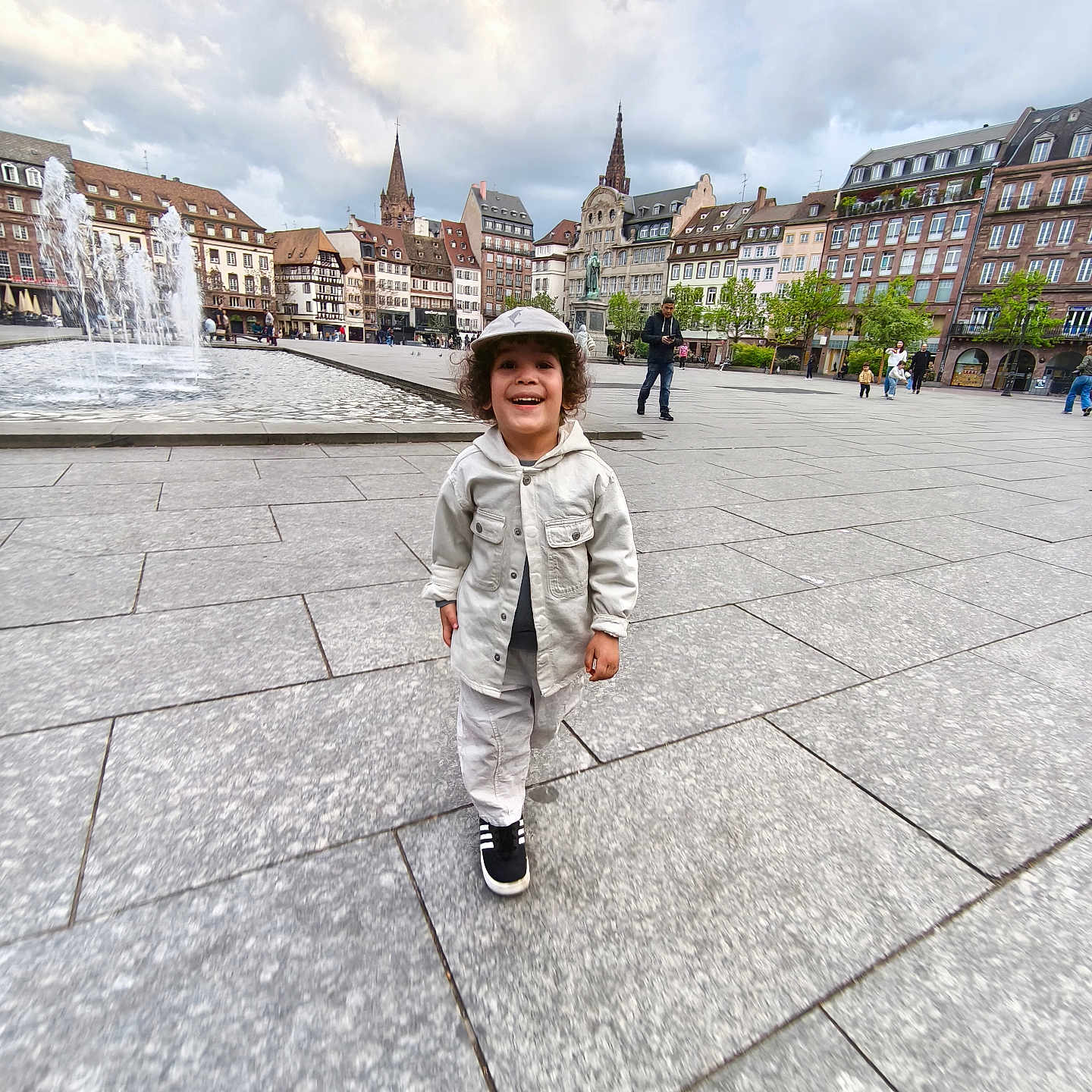 Iyan participe au concours pour gagner de l'argent avec cette photo : accessories, architecture, bag, boy, building, child, city, clothing, coat, face, footwear, head, male, pants, person, photography, portrait, shoe, standing, urban