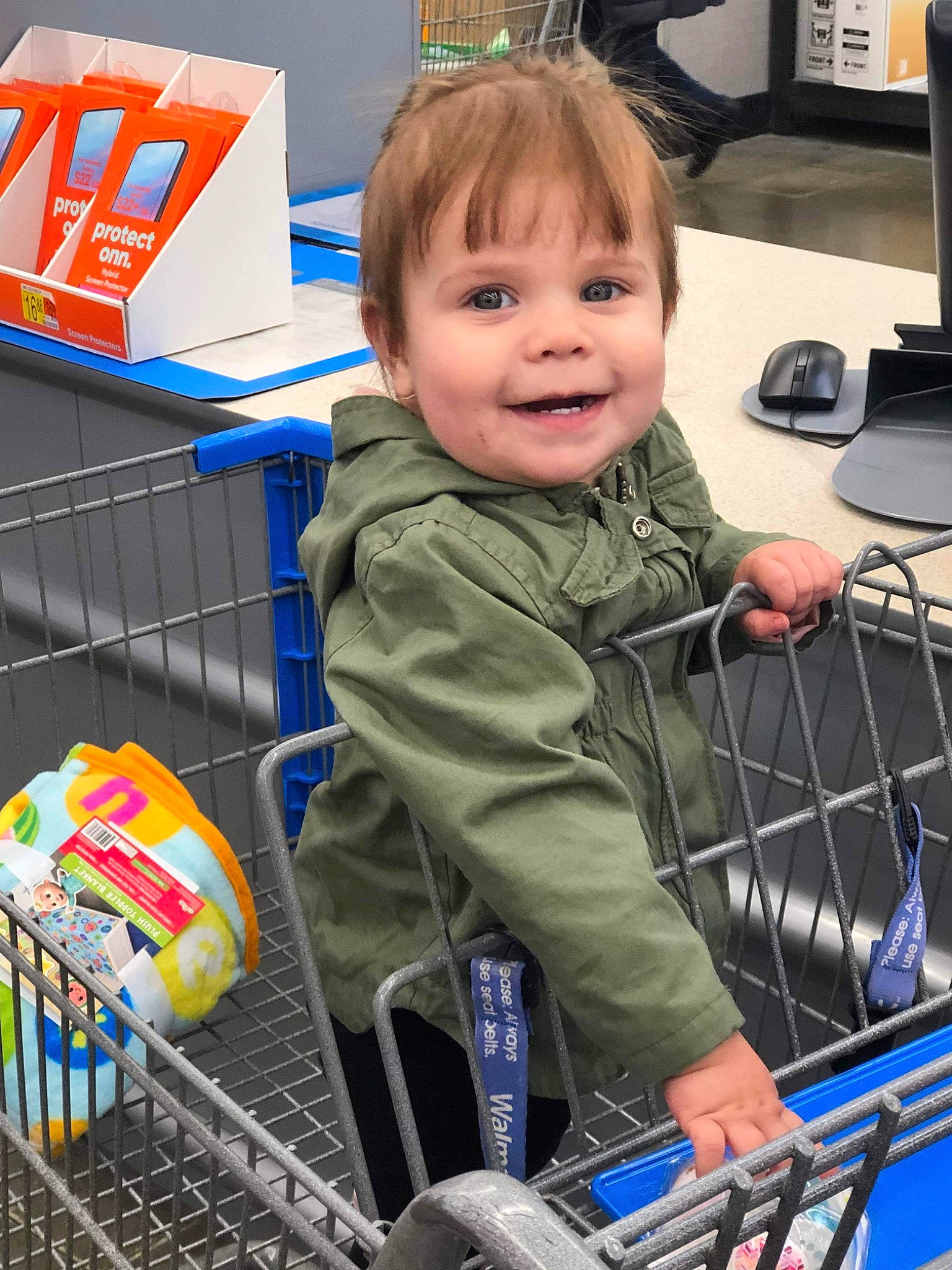 Armani is registered to the contest to win money with this photo: blue, child, computer_keyboard, electric_blue, engineering, fun, hoodie, joy, logo, motor_vehicle, peripheral, person, product, retail, service, shopping, shopping_cart, sitting, smile, supermarket