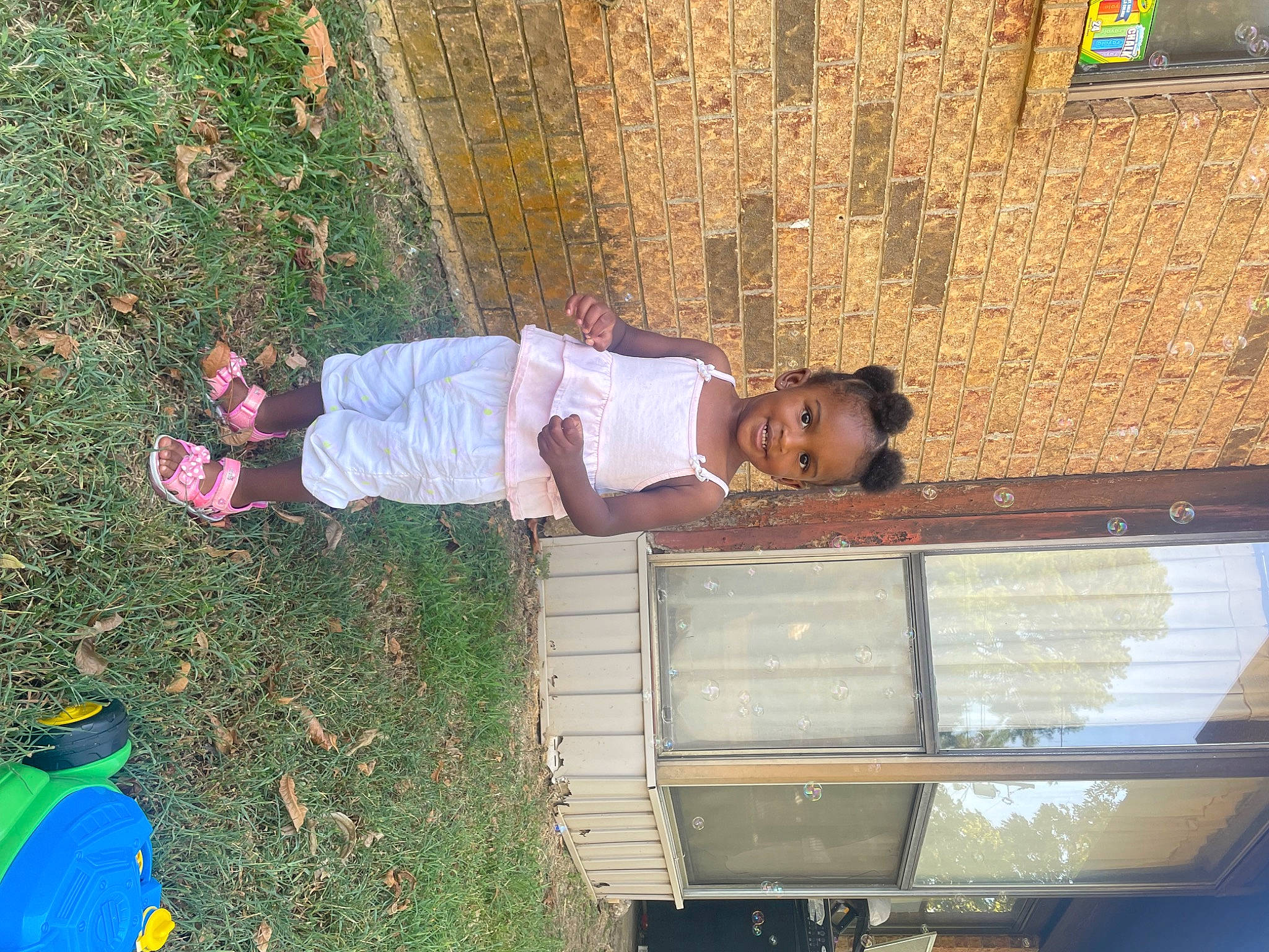 Janiya is registered to the contest to win money with this photo: baby_toddler_clothing, baseball_cap, cap, child, fun, grass, green, hat, joy, leisure, motor_vehicle, people_in_nature, person, t_shirt, tire, toddler, truck, vehicle