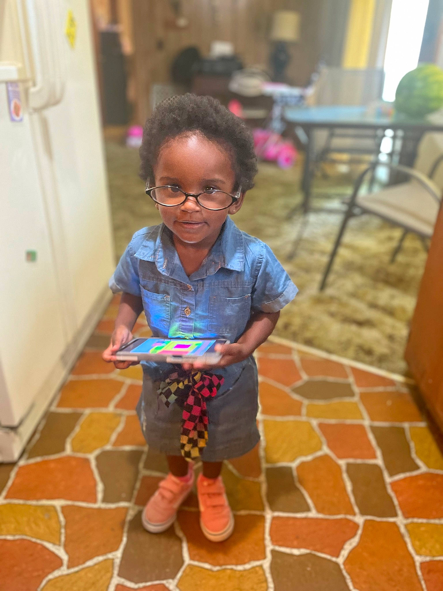 Janiya joined the competition — help win amazing prizes! chair, child, door, event, floor, flooring, fun, happy, leisure, pattern, person, play, recreation, room, sandal, sitting, smile, toddler, vacation, wood