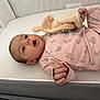 Lyvia a rejoint le concours — aidez-le/la à gagner de superbes lots ! baby, infant, crib, plush_toy, pink_clothing, floral_pattern, sleepwear, bed, nursery, child, cute, expression, face, hand, lying_down, soft_toy, indoors, comfort, peaceful, newborn