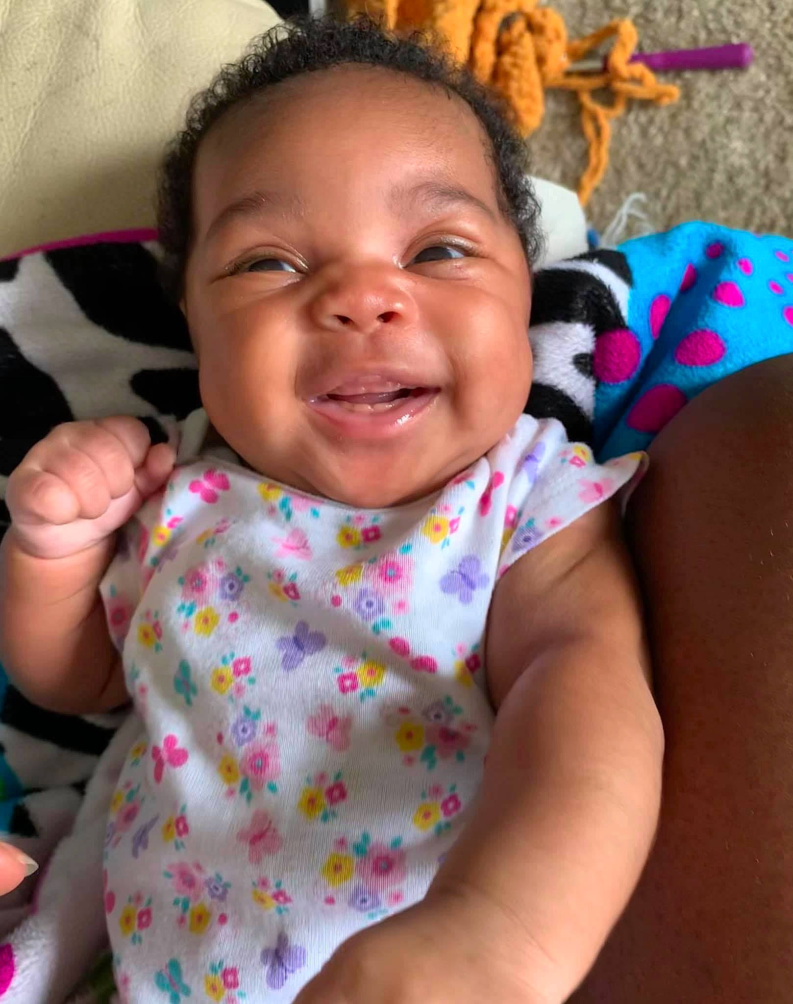 Melyia is registered to the contest to win money with this photo: baby, baby_toddler_clothing, cheek, child, dreadlocks, finger, happy, laugh, nail, person, skin, thumb, toddler, tooth, toy