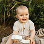 baby, child, smiling, blue_eyes, outdoor, greenery, flowers, blanket, number_one, grass, nature, cute, happy, sitting, infant, clothing, portrait, skin, hand, foot