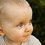 baby, child, face, blue_eyes, curious, close_up, portrait, skin, hair, outdoor, natural_light, expression, clothing, ribbed_shirt, infant, young_child, person, cute, head, looking_away