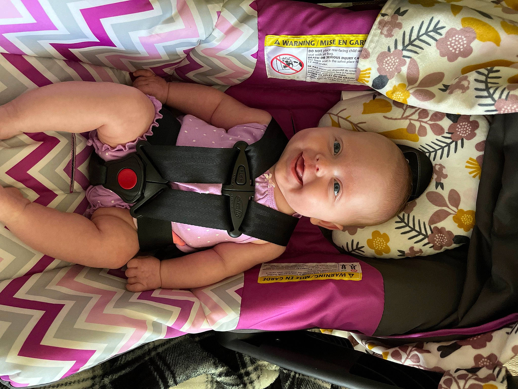 Everly is registered to the contest to win money with this photo: baby, baby_carriage, baby_products, baby_toddler_clothing, cheek, child, comfort, eye, fun, happy, magenta, pattern, person, pink, purple, room, skin, smile, textile, thigh