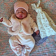 Maëlyne participe au concours pour gagner de l'argent avec cette photo : baby, newborn, sleeping, pink_clothing, hat, blanket, crocheted_blanket, soft_toy, bunny, comforter, infant, cute, peaceful, child, footed_pajamas, indoor, portrait, sleep, rest, cozy