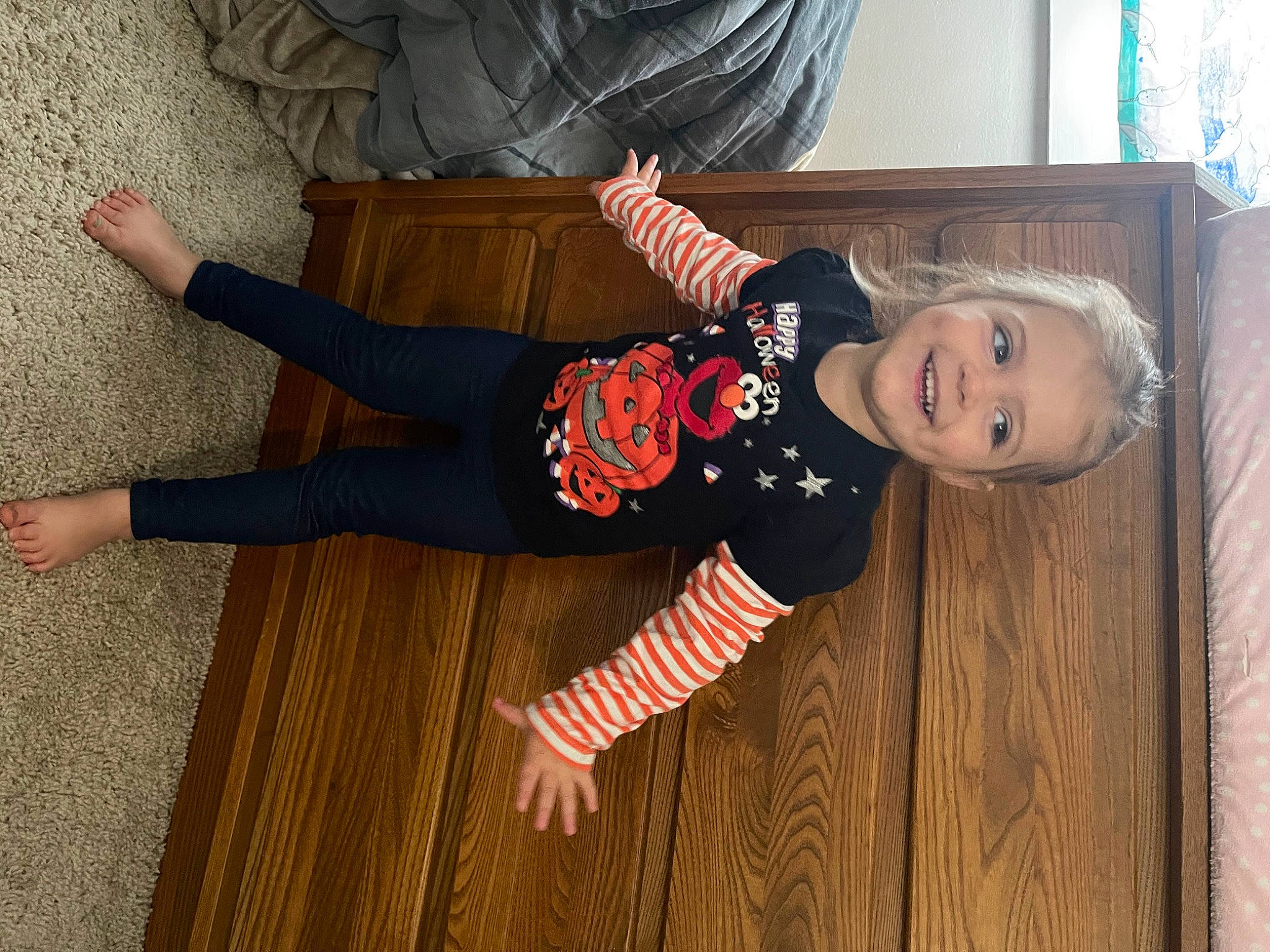Kinsley is registered to the contest to win money with this photo: baby, baby_toddler_clothing, child, floor, flooring, fun, happy, hardwood, hat, joy, knee, pattern, person, sleeve, smile, sock, textile, toddler, varnish, wood