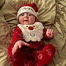 Bryce joined the competition — help win amazing prizes! baby, infant, child, christmas, santa_hat, festive, red_clothing, pajamas, bib, bed, bedding, indoors, portrait, lying_down, sitting, wide_eyed, face, smiling, holiday, cozy