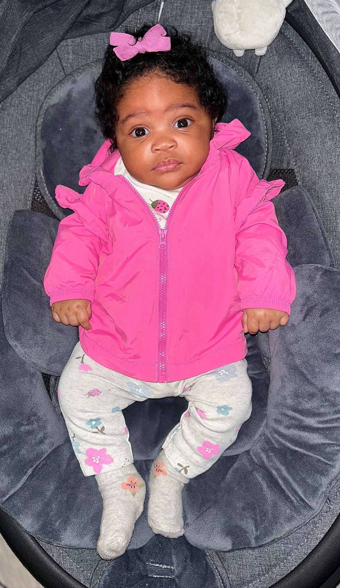 Ailani is registered to the contest to win money with this photo: baby, clothing, coat, cushion, face, footwear, happy, head, homedecor, hosiery, jacket, pants, person, photography, portrait, purple, shoe, sitting, smile, sock