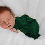 Jesse is registered to the contest to win money with this photo: newborn, baby, sleeping, infant, green_clothing, blanket, soft, cozy, peaceful, face, hand, portrait, rest, cute, child, young, warm, comfort, white, relax