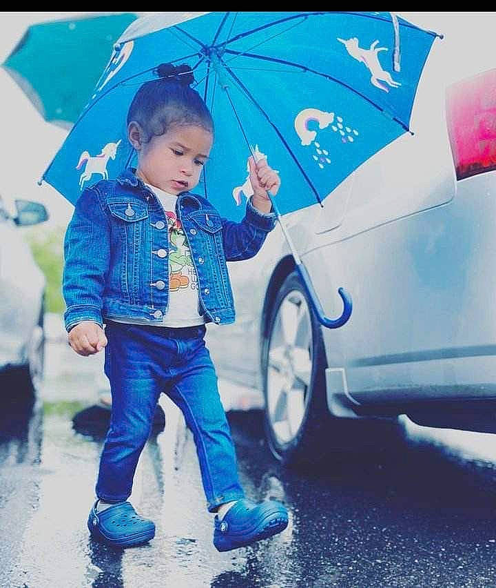 Heaven is registered to the contest to win money with this photo: alloy_wheel, automotive_design, automotive_lighting, automotive_tire, blue, car, cool, electric_blue, fender, fun, happy, hood, motor_vehicle, person, standing, tints_and_shades, tire, toddler, vehicle, vehicle_door