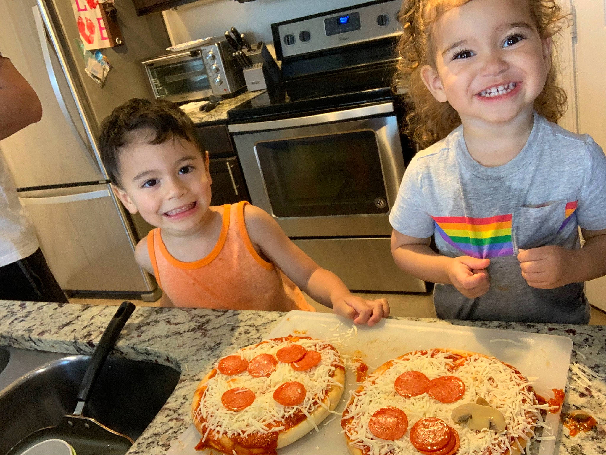 Maisyn is registered to the contest to win money with this photo: art, baked_goods, cabinetry, chair, cooking, countertop, cuisine, food, home_appliance, ingredient, joy, kitchen, kitchen_appliance, person, pizza, plate, recipe, smile, t_shirt, table