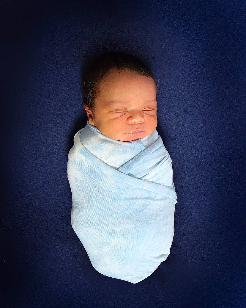 Coby is registered to the contest to win money with this photo: baby, baby_toddler_clothing, cheek, chin, collar, comfort, electric_blue, face, flash_photography, hairstyle, head, jacket, linens, neck, nose, outerwear, person, skin, sleeve, t_shirt