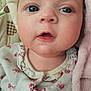 baby, close_up, face, blue_eyes, infant, child, pink_blanket, floral_clothing, soft_texture, cute, portrait, skin, young, expression, indoors, sleepwear, newborn, mouth_open, eyelashes, head