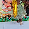toddler, child, balloon, birthday, dress, table, footwear, cartoon, princess, celebration, party, green_dress, outdoor, portrait, person, smiling, cute, young_child, event, colorful