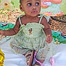 Na'Ryhia Smith is registered to the contest to win money with this photo: toddler, child, girl, green_dress, headband, sitting, outdoor, playmat, cartoon_backdrop, curious_look, shoes, baby, cute, portrait, celebration, birthday_dress, nature, happy, young_child, innocence