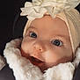Romy a rejoint le concours — aidez-le/la à gagner de superbes lots ! adorable, baby, blue_eyes, car_seat, child, closeup, coat, cute, expression, face, flower, fur, headband, infant, person, portrait, smile, soft_texture, warm_clothing, young