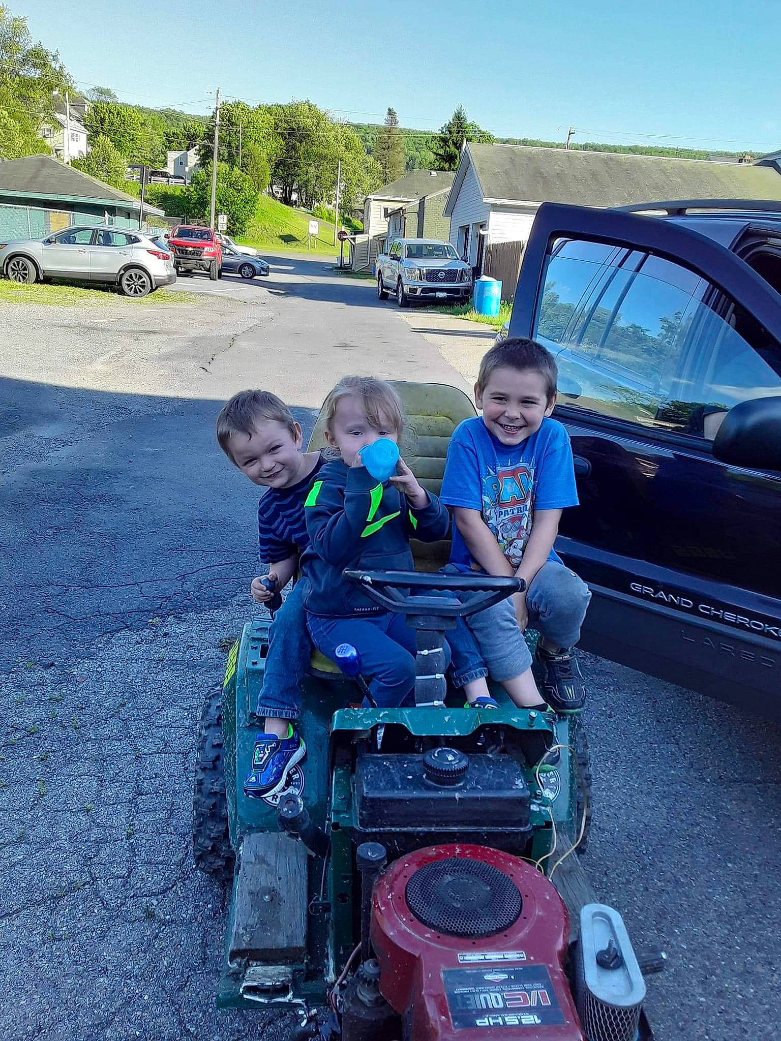 Kolton is registered to the contest to win money with this photo: asphalt, auto_part, automotive_design, automotive_exterior, automotive_tire, automotive_wheel_system, bumper, car, fender, grass, joy, land_vehicle, motor_vehicle, person, sky, smile, tire, tree, vehicle, vehicle_door