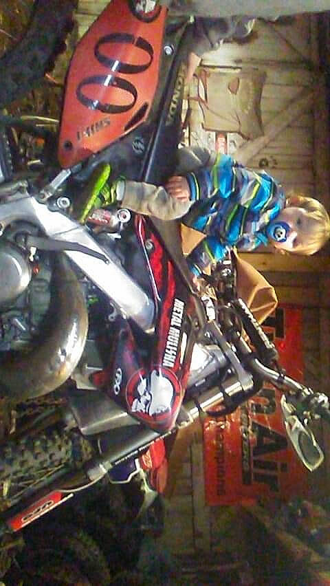 Kolton is registered to the contest to win money with this photo: action_figure, auto_part, automotive_lighting, automotive_tire, carmine, fictional_character, headlamp, machine, mecha, metal, motor_vehicle, motorcycle, motorcycle_accessories, person, personal_protective_equipment, recreation, rim, spoke, tire, toy