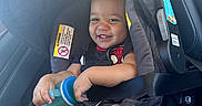 August joined the competition — help win amazing prizes! baby, car_seat, child, clothing, cute, hair, happy, holding, infant, interior, person, safety, seat, seatbelt, sippy_cup, skin, smiling, toddler, transportation, vehicle