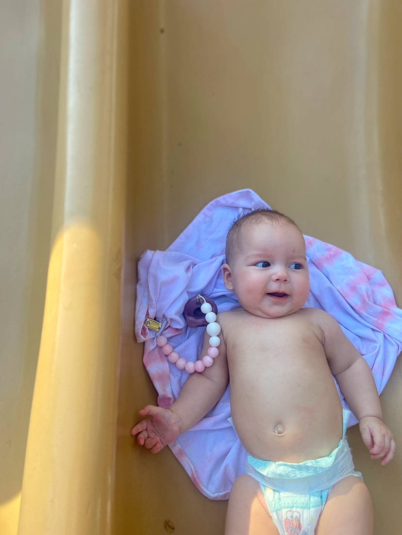 Evalynn joined the competition — help win amazing prizes! baby, baby_toddler_clothing, cheek, chest, diaper, eye, facial_expression, happy, human_body, iris, leg, mouth, person, product, skin, smile, stomach, thigh, thumb, toddler