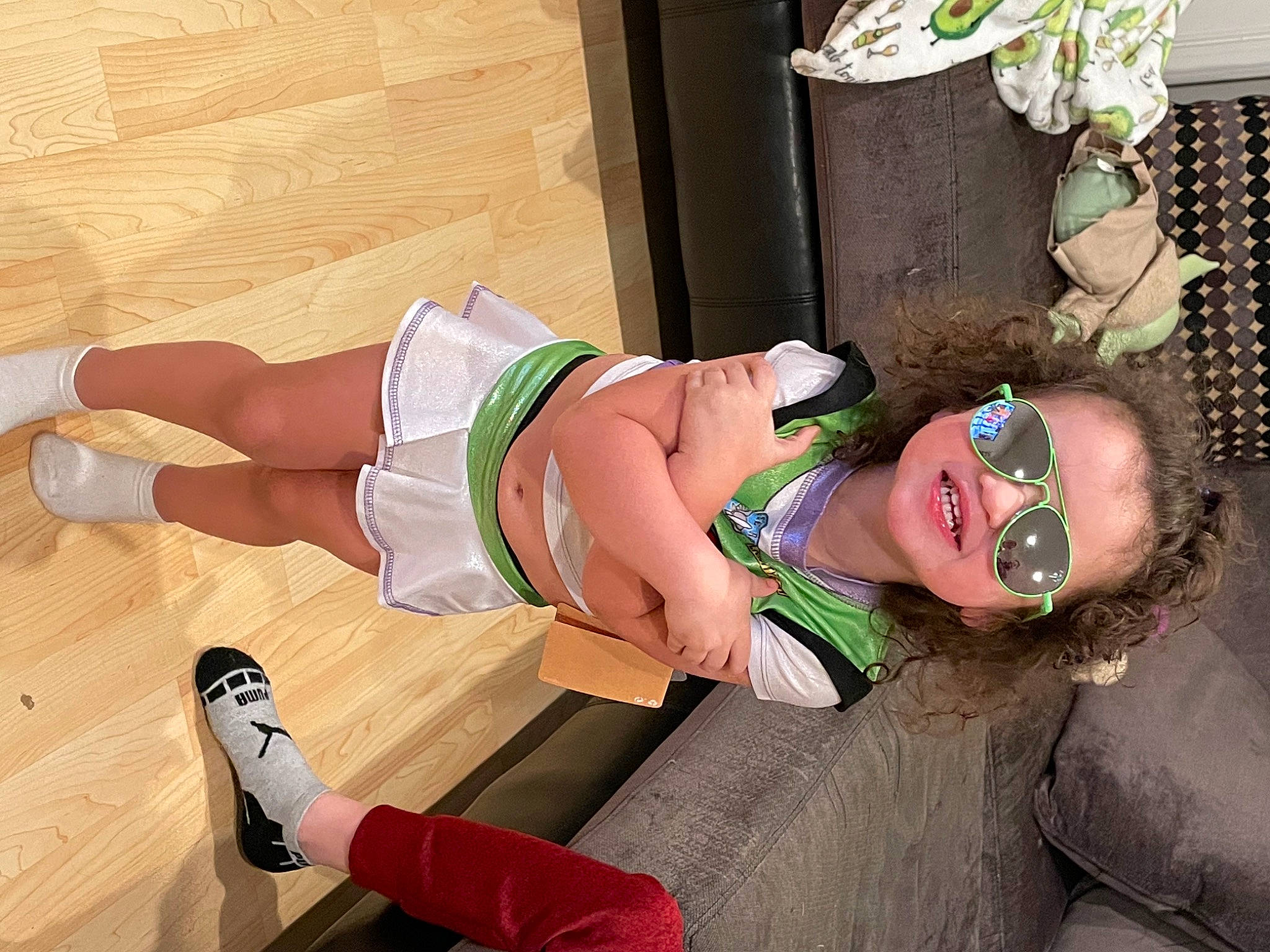 Mia is registered to the contest to win money with this photo: abdomen, chest, costume, eyewear, foot, hardwood, hat, human_leg, joy, knee, leg, person, plant, sandal, shoe, smile, sunglasses, thigh, trunk, waist