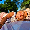 baby, child, smiling, tutu, headband, bow, outdoor, sunlight, blanket, portrait, happy, cute, infant, nature, greenery, blue_sky, person, lying_down, toddler, soft