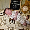 baby, infant, sleeping, blanket, crochet, bear, teddy_bear, sign, letter_board, clothing, onesie, cute, soft, cozy, newborn, child, portrait, indoor, rest, adorable