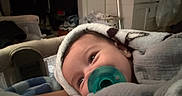 Jvanni joined the competition — help win amazing prizes! baby, pacifier, blanket, indoor, infant, face, child, soft, warm, comfort, furniture, home, portrait, closeup, cozy, wrapped, sleepy, resting, person, cute