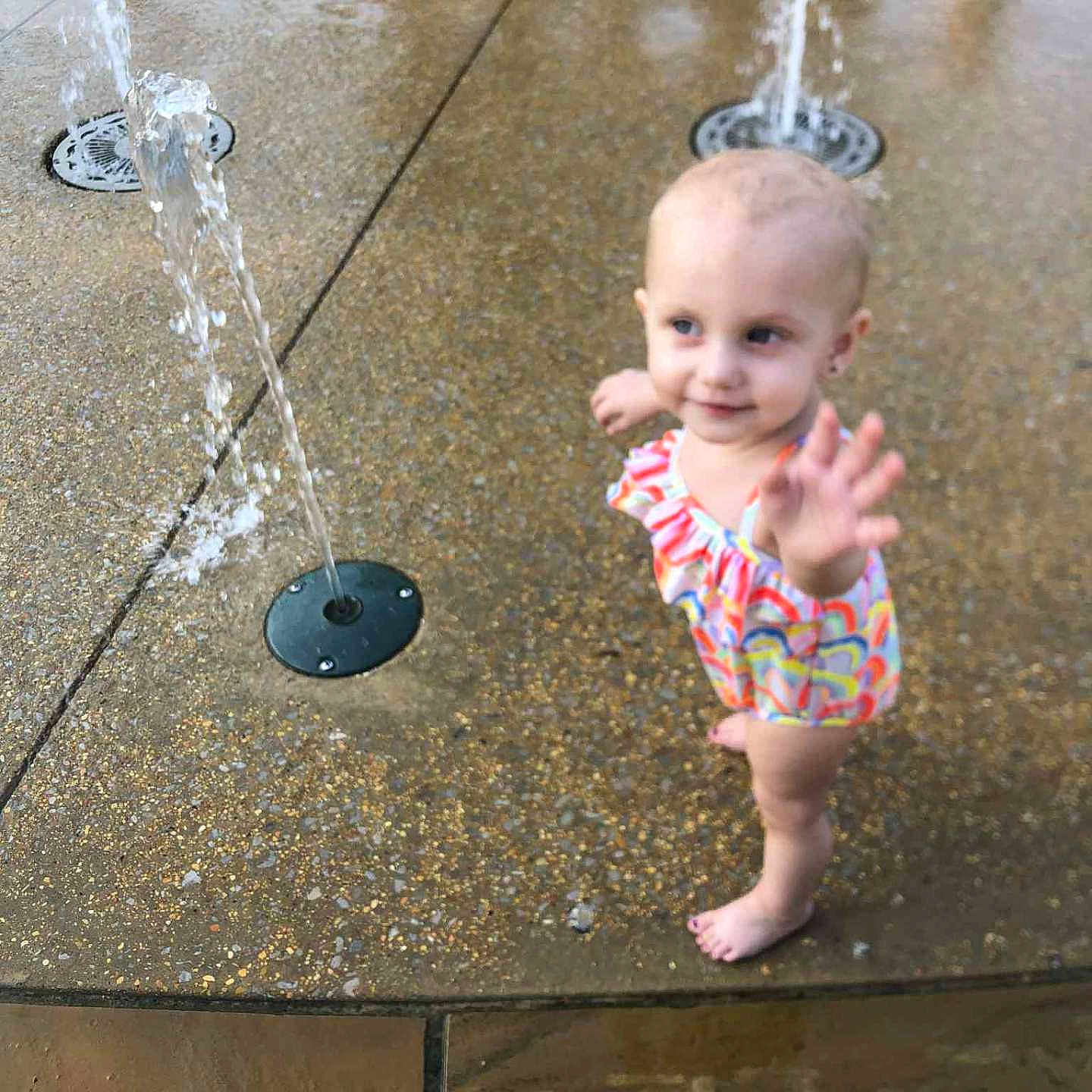 Jalice joined the competition — help win amazing prizes! barefoot, child, colorful, curious, daytime, fountain, fun, happy, outdoor, park, play, playground, reaching, summer, swimsuit, toddler, water, water_fountain, wet_surface, young_child