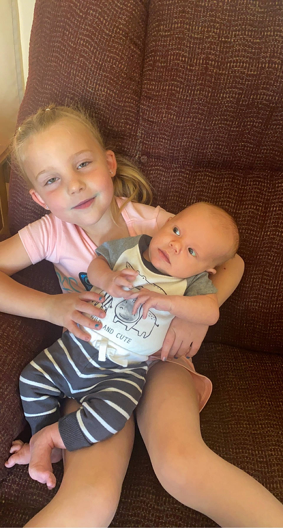 Emberlee is registered to the contest to win money with this photo: arm, cheek, comfort, eye, face, facial_expression, finger, gesture, human_body, interaction, iris, joint, joy, lap, leg, mouth, muscle, person, shoulder, skin