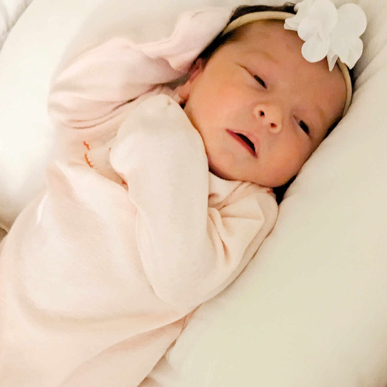 Azsarah Reign is registered to the contest to win money with this photo: baby, child, closeup, cozy, cushion, cute, flower, headband, human, indoors, infant, newborn, peaceful, pillow, pink_clothing, portrait, resting, skin, sleeping, soft_fabric