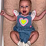 arms_outstretched, baby, blue_eyes, child, cute, denim, happy, head, heart, indoor, infant, lying_down, person, pink_trim, portrait, short_sleeves, skin, smiling, towel, white_socks