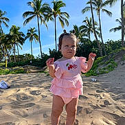 Svetlana joined the competition — help win amazing prizes! toddler, child, beach, sand, palm_trees, sunny, outdoor, blue_sky, greenery, pink_clothing, barefoot, cute, summer, nature, portrait, young_child, vacation, sunlight, small_hands, determined