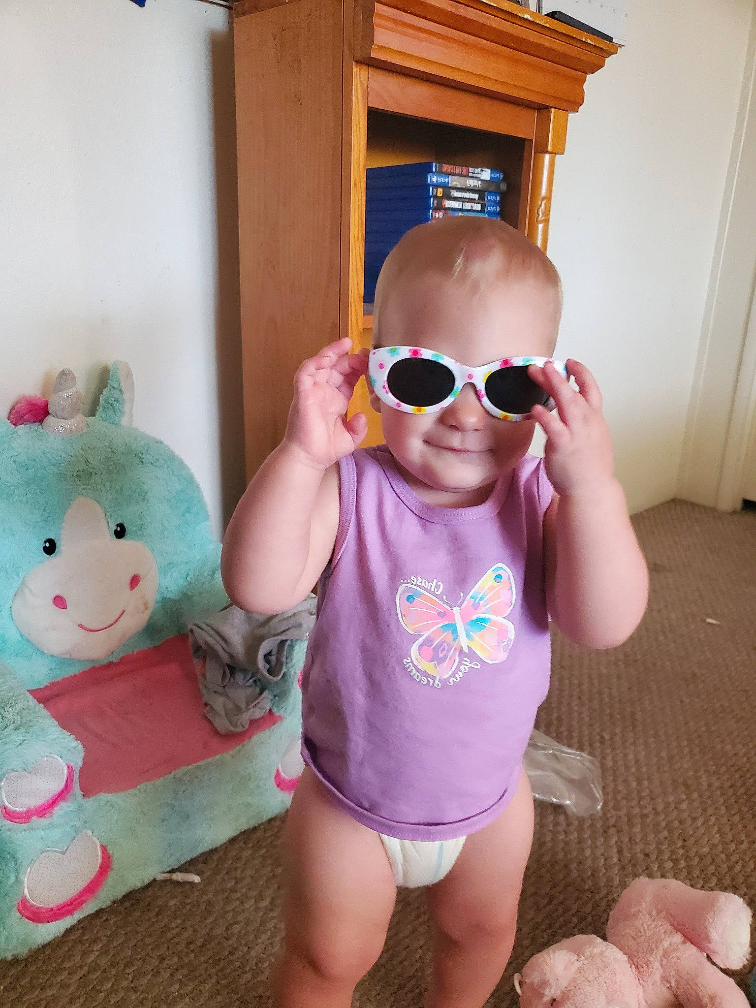 Adalene is registered to the contest to win money with this photo: baby, baby_toddler_clothing, cheek, child, cool, ear, eyewear, glasses, leg, person, pink, product, room, skin, smile, summer, sunglasses, toddler, vacation, vision_care
