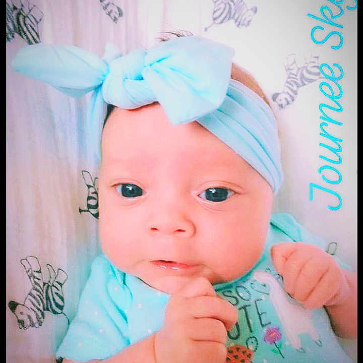 Journee is registered to the contest to win money with this photo: aqua, azure, baby, baby_toddler_clothing, cap, cheek, child, costume_hat, eyelash, face, font, happy, headband, headgear, headpiece, magenta, pink, skin, sleeve, toddler