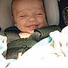 Alice is registered to the contest to win money with this photo: baby, car_seat, smile, closed_eyes, blanket, infant, child, safety_strap, graco, face, cute, sleeping, comfort, seatbelt, young_child, indoor, portrait, baby_clothing, head, peaceful