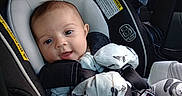 Alice is registered to the contest to win money with this photo: baby, car_seat, pajamas, panda_print, smiling, infant, seatbelt, child, safety, cute, indoors, clothing, seat, restraint, car_interior, person, young_child, portrait, baby_clothes, comfort