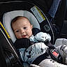 baby, car_seat, pajamas, panda_print, smiling, infant, seatbelt, child, safety, cute, indoors, clothing, seat, restraint, car_interior, person, young_child, portrait, baby_clothes, comfort