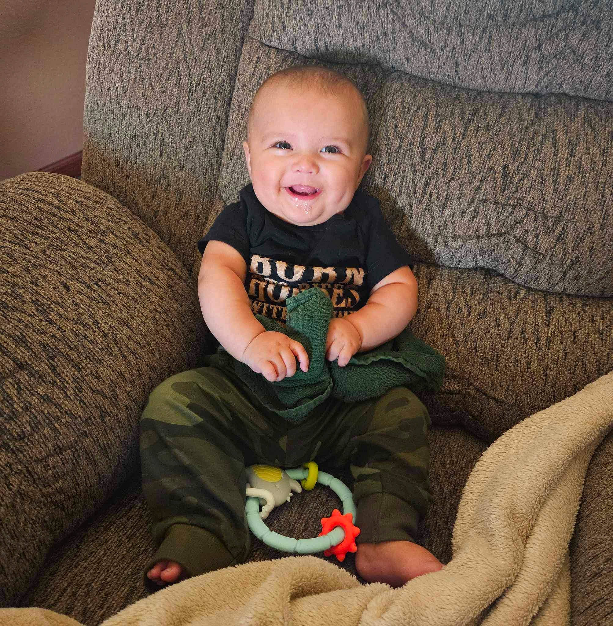 Leighton joined the competition — help win amazing prizes! arm, baby_toddler_clothing, cheek, comfort, couch, eye, face, finger, happy, head, human_body, iris, joy, lap, leg, mammal, person, skin, sleeve, smile
